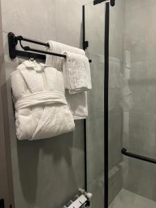 a bathroom with white towels and a shower at Dream Hotel in Almaty