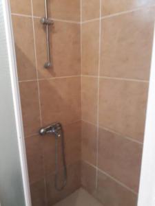 a shower with a shower head in a bathroom at Ocean Drive Studio, next to the Beach in Grand-Baie