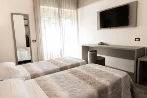 Postel nebo postele na pokoji v ubytování Hotel Casa Tra Noi