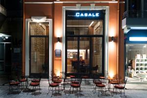 a group of chairs and tables in front of a store at Patras Casale in Patra