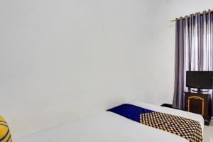 Postel nebo postele na pokoji v ubytování SPOT ON 91745 Rumah Kost Gresik Syariah
