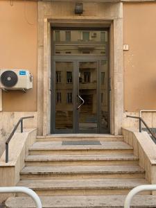a glass door of a building with stairs at B&S Home Vaticano in Rome