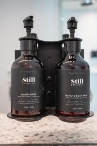 two bottles of hand soap sitting on a counter at The Langlands Hotel in Invercargill