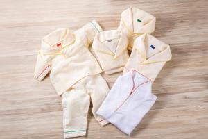 three pieces of clothing laying on a wooden floor at Oriental Hotel Tokyo Bay in Urayasu