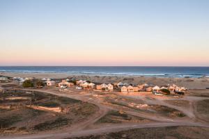 eine Luftblick auf einen Strand mit Häusern und das Meer in der Unterkunft Gnaraloo Station - Homestead in Carnarvon