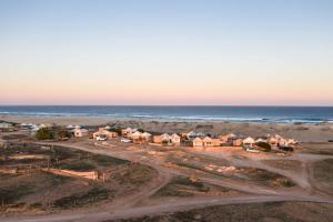 an aerial view of a beach with houses and the ocean at Gnaraloo Station - Homestead in Carnarvon
