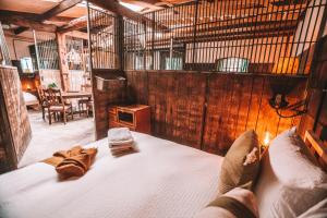 a bedroom with a bed in a room with wooden walls at CRASH'NSTAY - Paardenstal in Sprang-Capelle