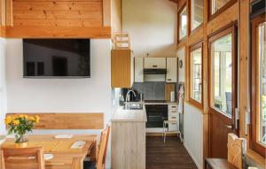 a kitchen and dining room with a table in a tiny house at Chalet Bestaenderhof in Obertal