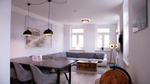 a living room with a table and a couch at Cityapartments am Hafen in Waren