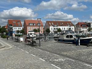 a group of boats docked at a marina with buildings at Cityapartments am Hafen in Waren