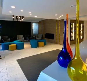two colorful vases sitting on a table in a lobby at Solho Hotel in Bardolino
