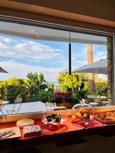 a breakfast table with a view of the ocean at Villa Maria Luxury Suites in Sperlonga