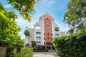 a building with a red and white tower at Bella Villa Pattaya 3rd Road in Pattaya Central