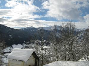 a snow covered building with a view of a valley at Ferienwohnungen Bacherhof in Sankt Michael im Lungau