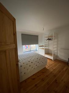 um quarto branco com uma cama e uma janela em Sulfer7 em Heuvelland