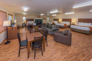 a hotel room with two beds and a living room at Nisqually Lodge in Ashford
