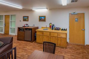 a kitchen with a counter and a table in a room at Nisqually Lodge in Ashford