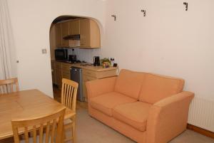 a living room with a couch and a table at Seashells Cottage in Gorleston-on-Sea