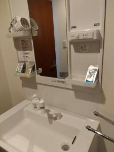 a bathroom with a sink and a mirror at Sankei Hiranomachi Building - Vacation STAY 13206 in Osaka