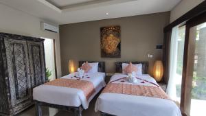 Kubu Garden Suites & Villas Nusa Dua客房内的一张或多张床位