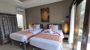 Kubu Garden Suites & Villas Nusa Dua客房内的一张或多张床位