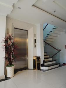 a lobby with a door and a potted plant at Yen Nam Hotel Nguyen Trong Tuyen in Ho Chi Minh City