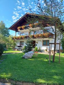 a large white house with flowers on the front of it at Frühstückspension Helmhof in Salzburg