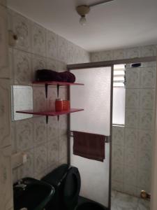 a bathroom with a shower and two shelves on the wall at Gianni´s in Arequipa