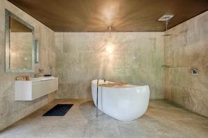 a bathroom with a white tub and a sink at Mudstone Suites in Pemberton