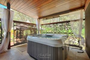 a hot tub in a room with a window at Mudstone Suites in Pemberton