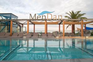 a swimming pool with a sign that reads main dam at MenDan Magic Spa & Wellness Hotel in Zalakaros