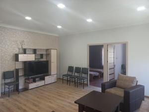 a living room with a couch and a tv and a table at Gam guest house 2 in Meghri
