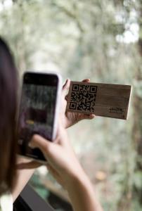 a person taking a picture with a cell phone at ARTOTEL Haniman Ubud in Ubud