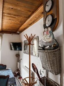 a room with a clock and a table and chairs at Holiday Home Amila in Visoko