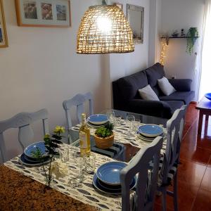 a dining room table with blue dishes on it at Cabo de Palos Apartment in Cabo de Palos