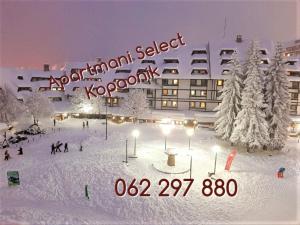 a large building with a sign in the snow at Select Lux Angella-Konaci in Kopaonik