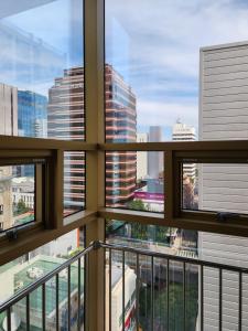 a view of a city from a building window at Gold Stone Hotel in Busan