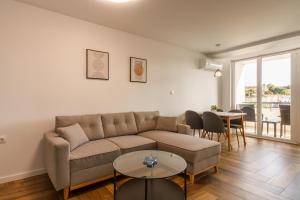 a living room with a couch and a table at South Panoramic Apartment in the art district of Kapana in Plovdiv