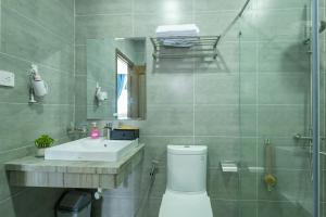 a bathroom with a toilet and a sink and a shower at V&T Hotel Phu Quoc - 3 minutes to Beach in Phú Quốc