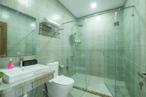 a bathroom with a shower and a toilet and a sink at V&T Hotel Phu Quoc - 3 minutes to Beach in Phú Quốc +110 photos