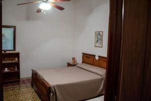 1 dormitorio con 1 cama y ventilador de techo en Appartamento Erice Bassa, en Trapani