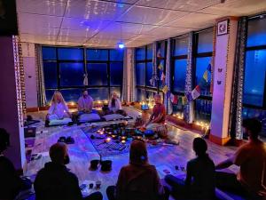 a group of people sitting in a room doing meditation at Yoga House in McLeod Ganj