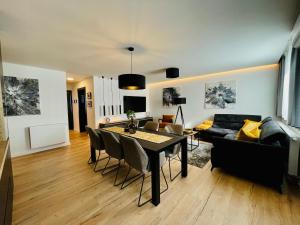 a living room with a table and a couch at Apartman Ana in Daruvar
