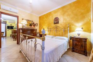 a bedroom with a bed with a white bedspread at Locazione Turistica Fusillo Lorusso con parcheggio privato in loco in Barletta