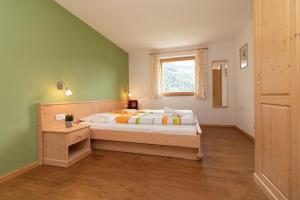 a bedroom with a bed and a window at Unterwegerhof in Tires