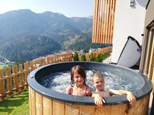 two children are sitting in a jacuzzi tub at Canalhof in Antermoia +36 photos
