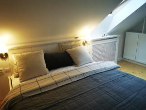 a bed with two pillows on it in a room at Leśniczówka in Lądek-Zdrój