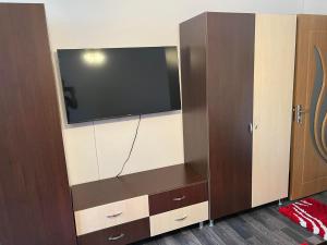 a large entertainment center with a flat screen tv at LA ALIS SI RAISA! Apartament cu 2 camere! in Lupeni