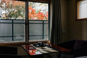 a room with a coffee table and a large window at Hotel Alza Kyoto in Kyoto