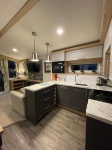 a kitchen with a sink and a counter top at PRESTIGE GOLF VILLAGE CARAVAN in Port Seton +5 photos